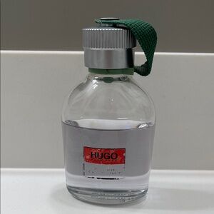 Hugo Boss Fragrance with Green Strap and Silver Cap 33FL OZ . 2/3 full